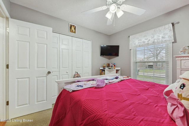 bedroom featuring carpet flooring, ceiling fan, and a closet