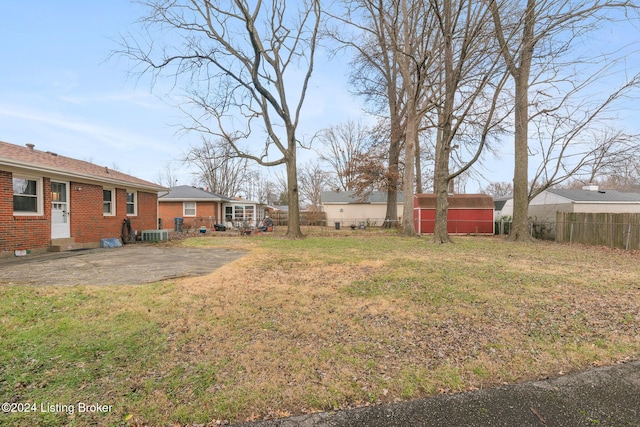 view of yard featuring central AC and a shed