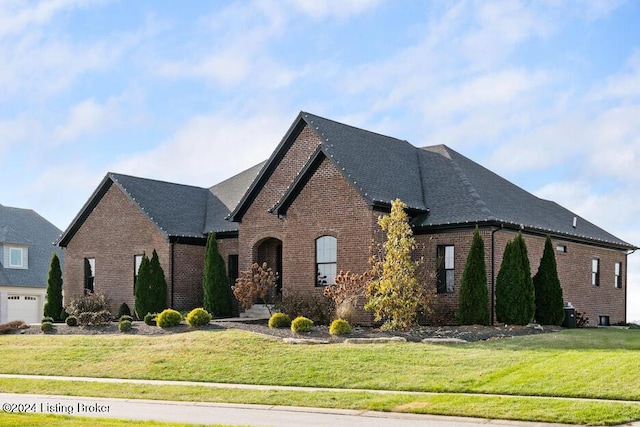 french country inspired facade with a front yard