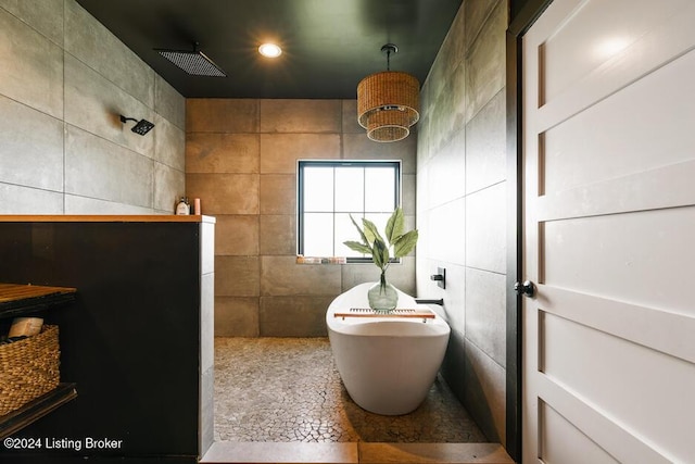 bathroom featuring tile walls and walk in shower