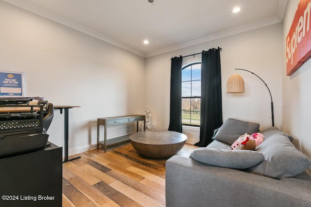 living area featuring ornamental molding and light hardwood / wood-style flooring