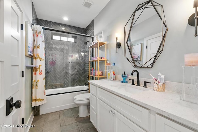 full bathroom featuring vanity, tile patterned floors, tiled shower / bath combo, and toilet