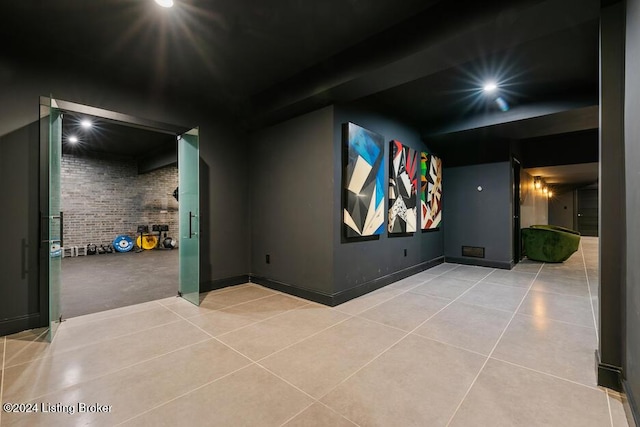 cinema with light tile patterned floors and brick wall