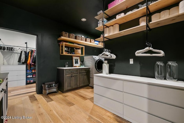 bathroom with hardwood / wood-style flooring and washer / dryer