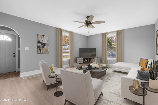 living room with ceiling fan and light hardwood / wood-style flooring