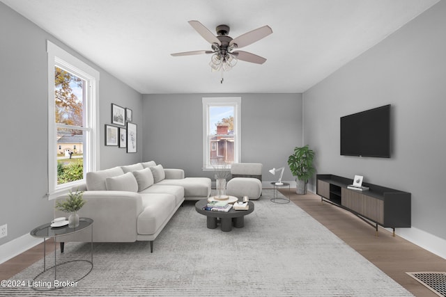 living room featuring hardwood / wood-style flooring, ceiling fan, and a healthy amount of sunlight