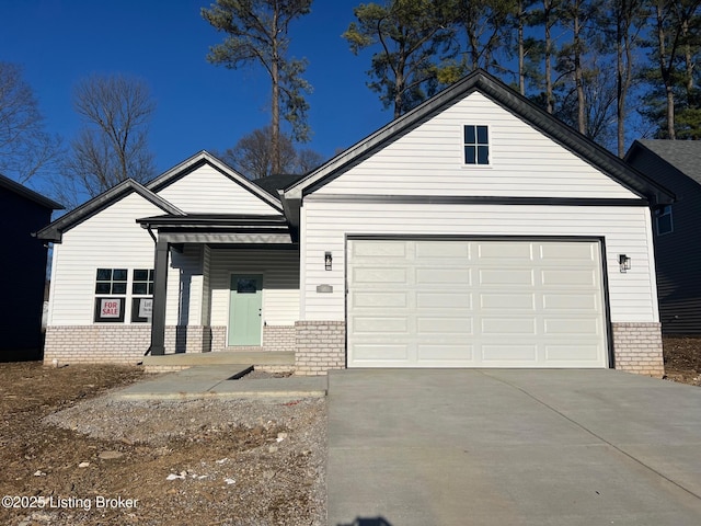 single story home featuring a garage, concrete driveway, brick siding, and a porch