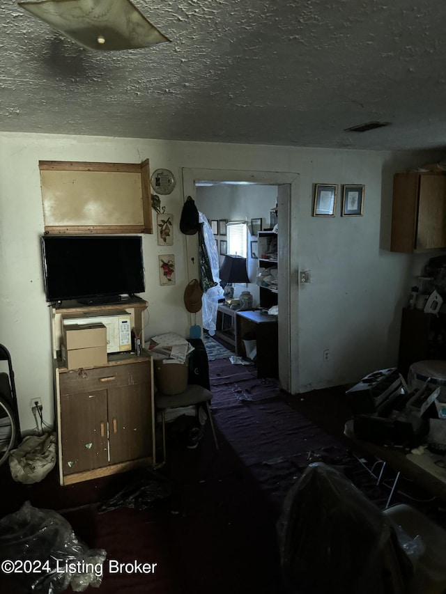 miscellaneous room with a textured ceiling