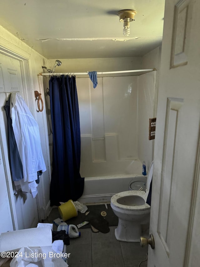 bathroom featuring tile patterned floors, toilet, and shower / bath combo with shower curtain