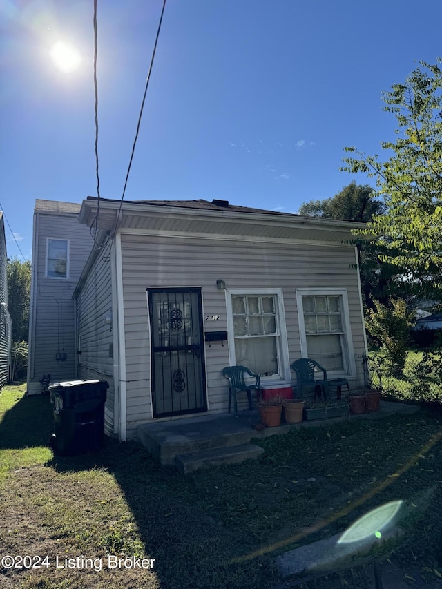 rear view of property with a yard