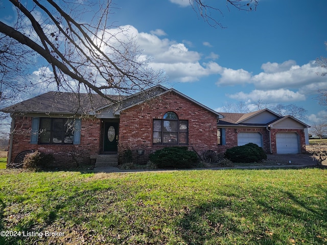 single story home featuring a garage and a front lawn