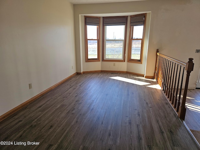 unfurnished room with dark hardwood / wood-style floors