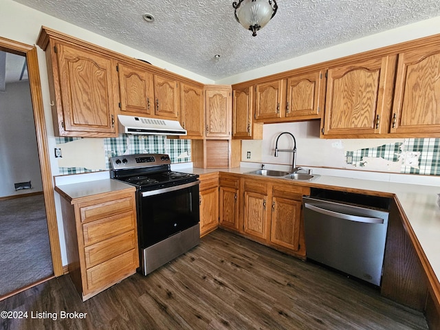 kitchen with dark hardwood / wood-style flooring, sink, a textured ceiling, and appliances with stainless steel finishes