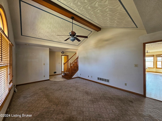 unfurnished living room with beamed ceiling, carpet, high vaulted ceiling, and ceiling fan