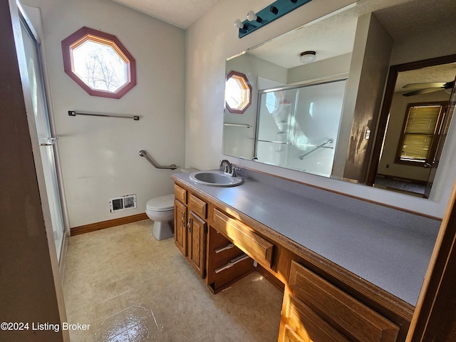 bathroom with vanity, toilet, and walk in shower