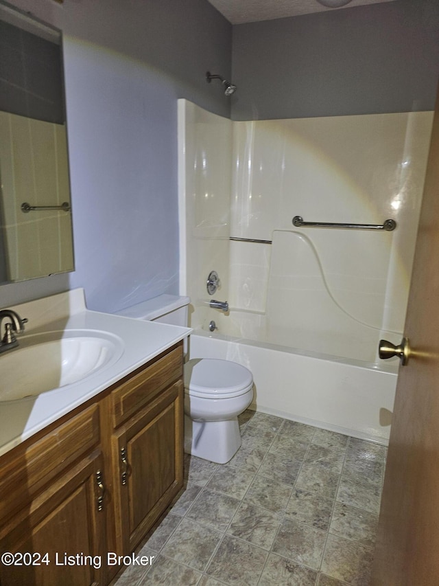 full bathroom featuring vanity, bathing tub / shower combination, and toilet