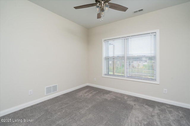 carpeted spare room with ceiling fan