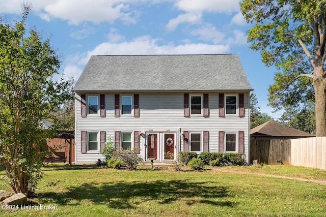 colonial inspired home with a front lawn