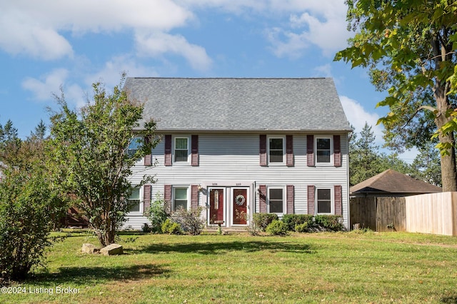 colonial inspired home with a front lawn