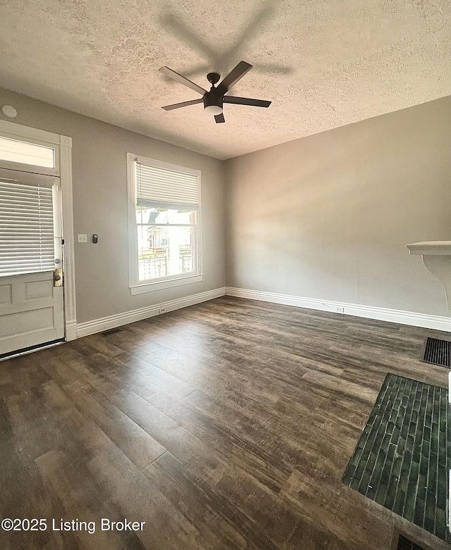 interior space with ceiling fan, dark hardwood / wood-style flooring, and a textured ceiling