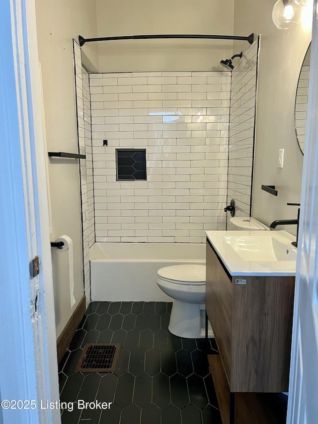 bathroom featuring visible vents, toilet, vanity, shower / tub combination, and tile patterned floors