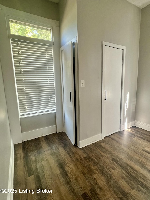 unfurnished bedroom featuring dark hardwood / wood-style flooring