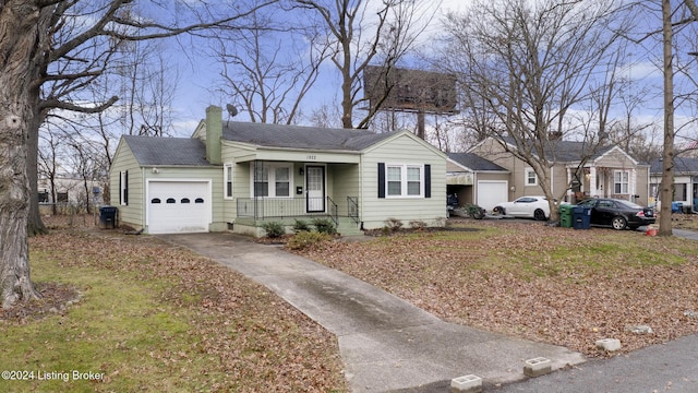 single story home with covered porch and a garage