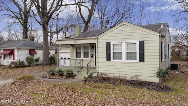 view of front of home featuring cooling unit and a garage