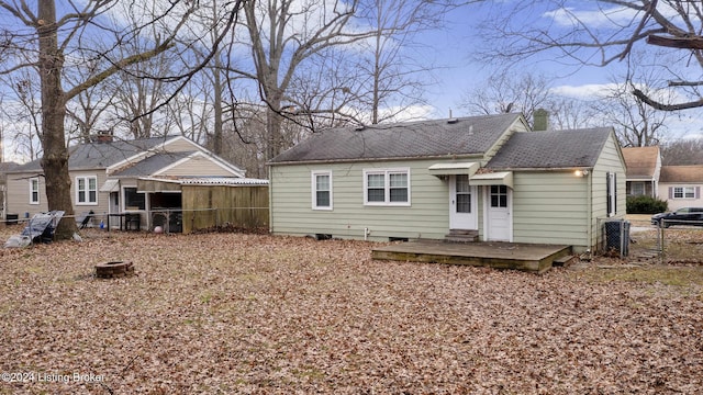 rear view of property featuring a wooden deck