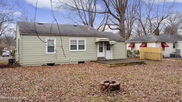 back of house with central AC unit and a wooden deck