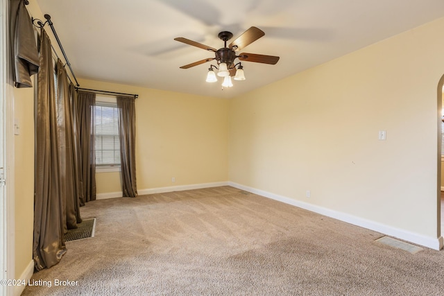 carpeted spare room featuring ceiling fan