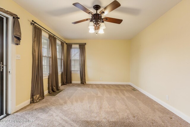 carpeted empty room featuring ceiling fan