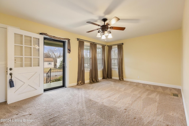 carpeted empty room featuring ceiling fan