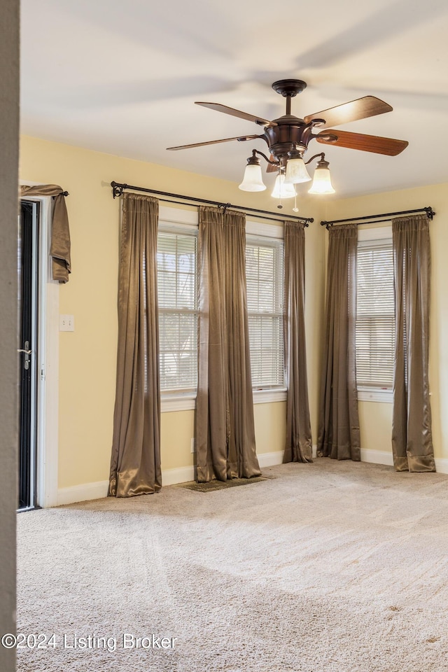 unfurnished room with ceiling fan and carpet floors