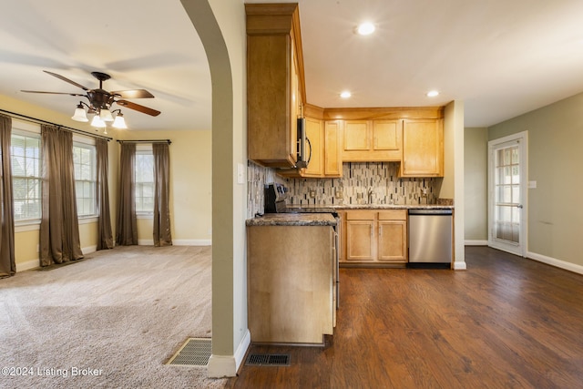 kitchen featuring tasteful backsplash, dark stone counters, stainless steel appliances, ceiling fan, and light brown cabinets