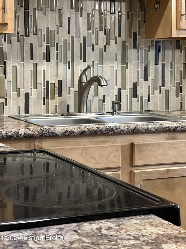 room details featuring backsplash and sink