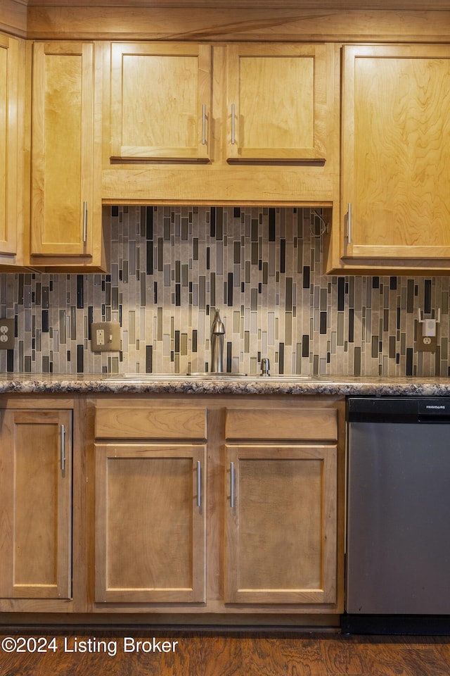 kitchen featuring decorative backsplash, stainless steel dishwasher, and stone counters