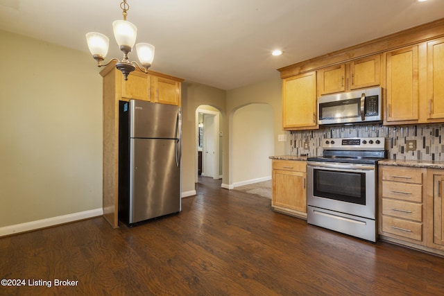 kitchen with decorative backsplash, dark wood-type flooring, stainless steel appliances, and light stone counters