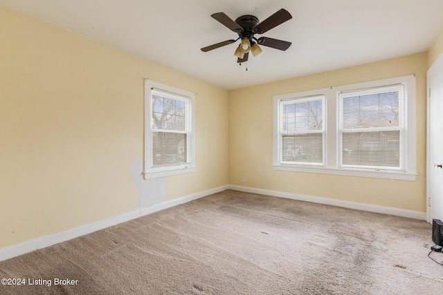 empty room with carpet flooring and ceiling fan