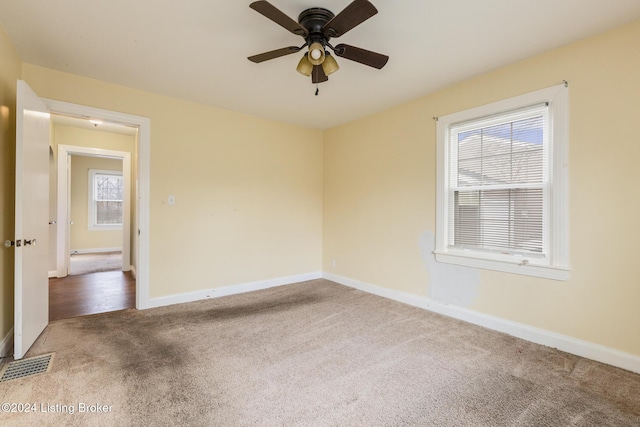 empty room with carpet flooring and ceiling fan