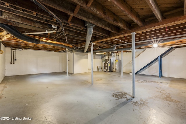 basement with water heater and heating unit