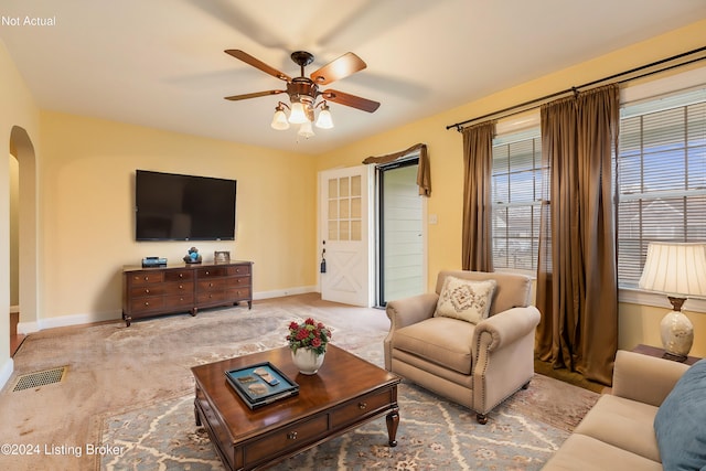 living room with ceiling fan and light colored carpet