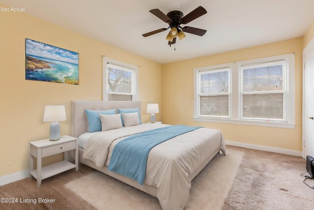 bedroom with ceiling fan and light carpet