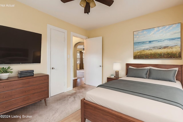 bedroom featuring ceiling fan and light carpet