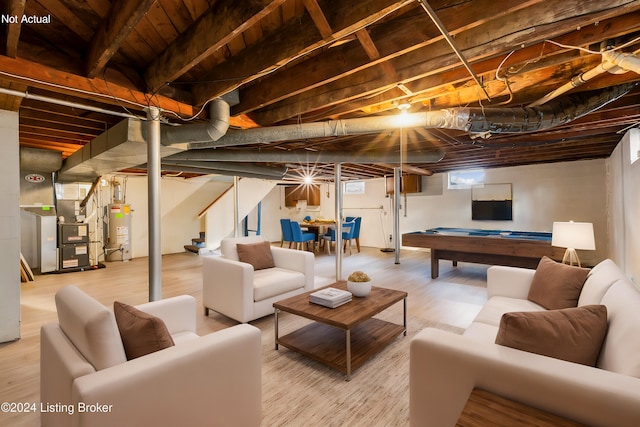 basement with heating unit, wood-type flooring, gas water heater, and pool table