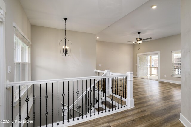 hall featuring hardwood / wood-style floors and a notable chandelier