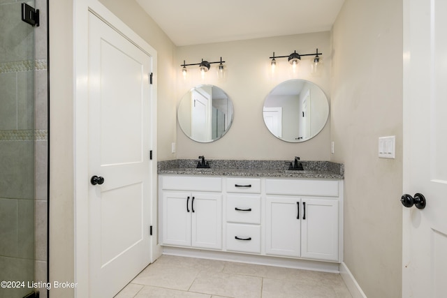 bathroom with tile patterned flooring and vanity