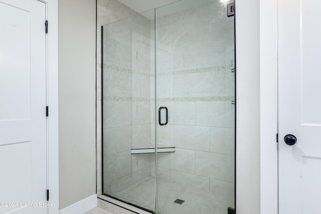 bathroom with a shower with shower door