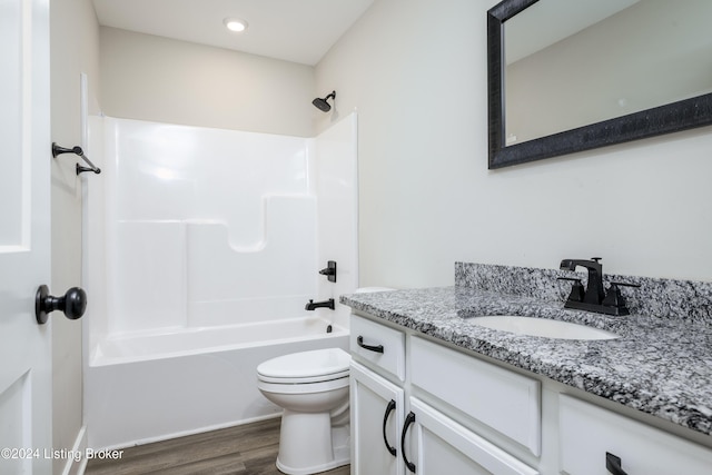 full bathroom featuring shower / tub combination, vanity, hardwood / wood-style flooring, and toilet