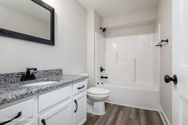 full bathroom featuring bathing tub / shower combination, vanity, hardwood / wood-style flooring, and toilet